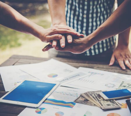 Business people making pile of hands. Teamwork concept.